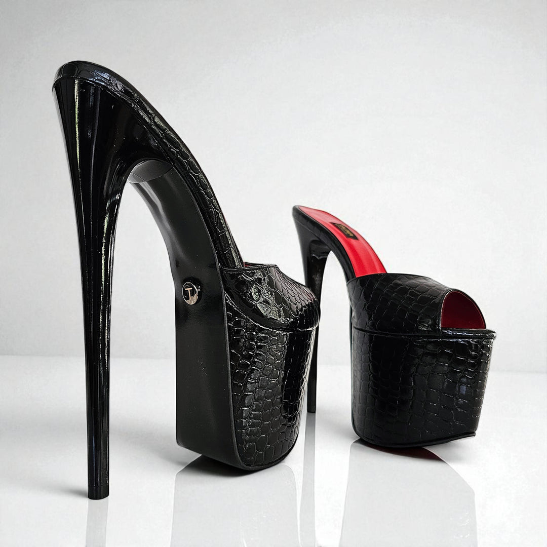 Black high-heeled shoes with red interior on a white background