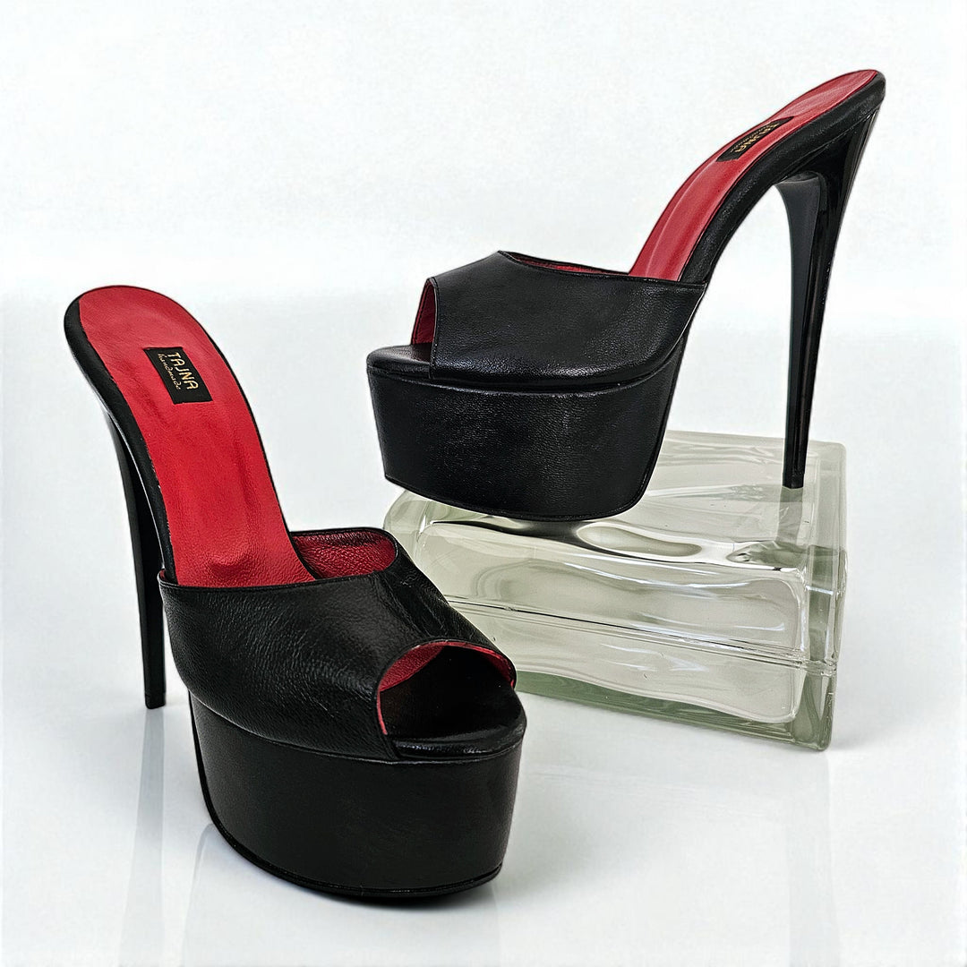 Black high-heeled shoes with red interior on a white background
