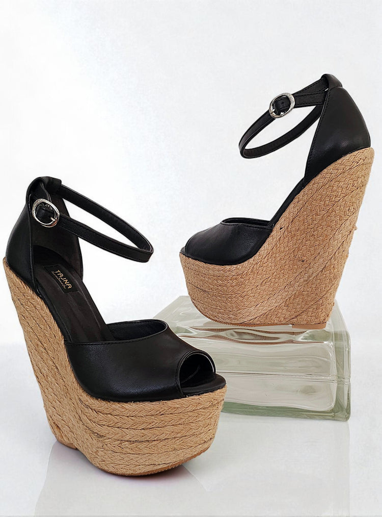 Black wedge sandals with jute sole on a white background