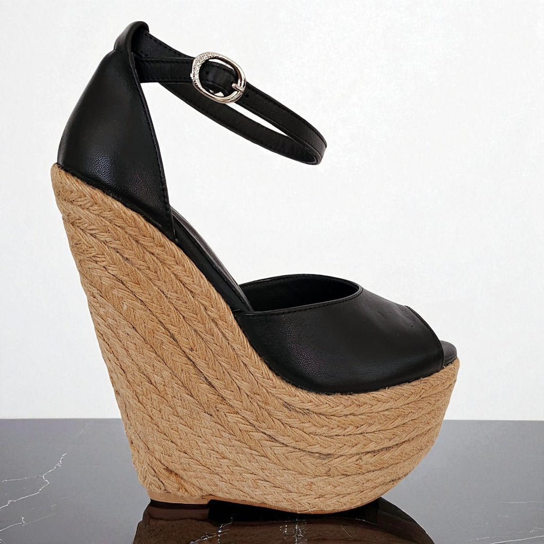 Black wedge sandal with woven wedge on a white background