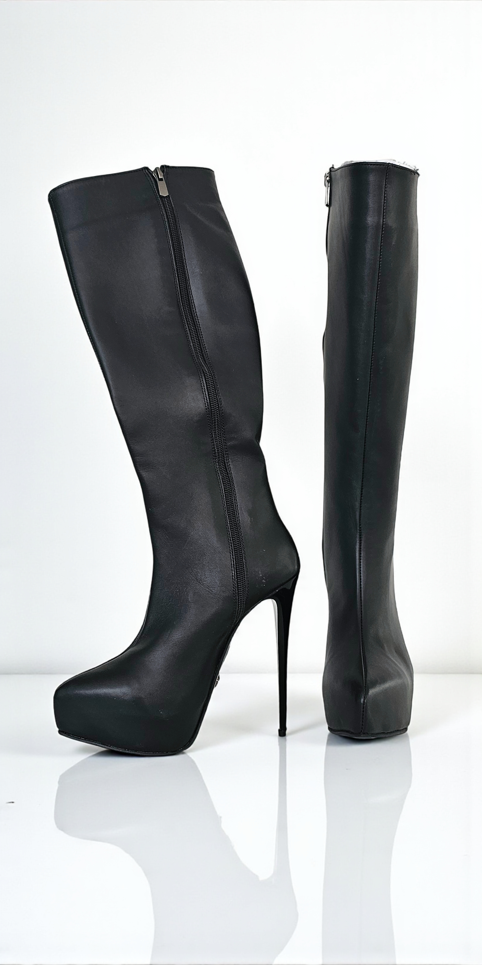 Black knee-high boots with high heels on a white background