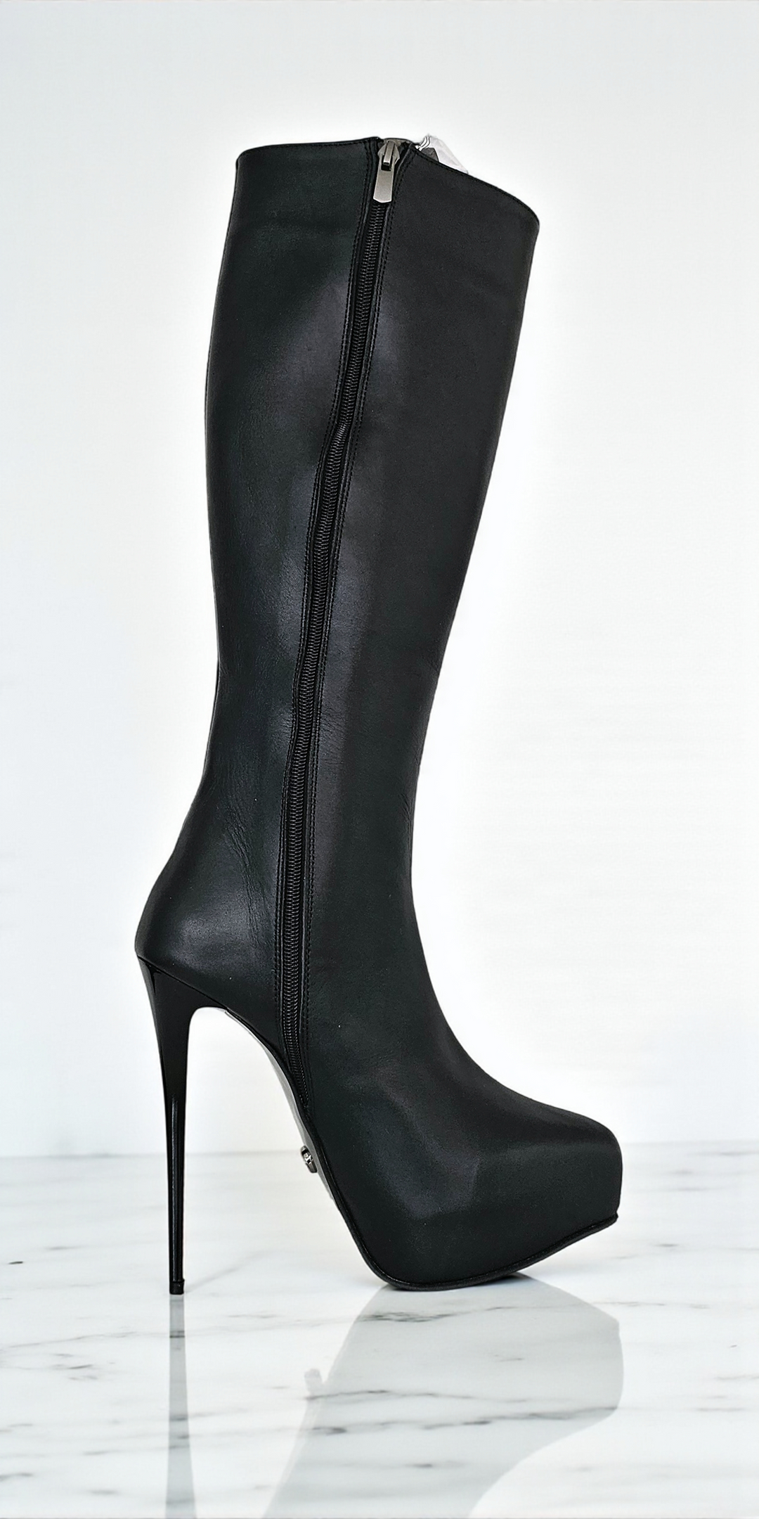 Black knee-high boot with high heel on a white background