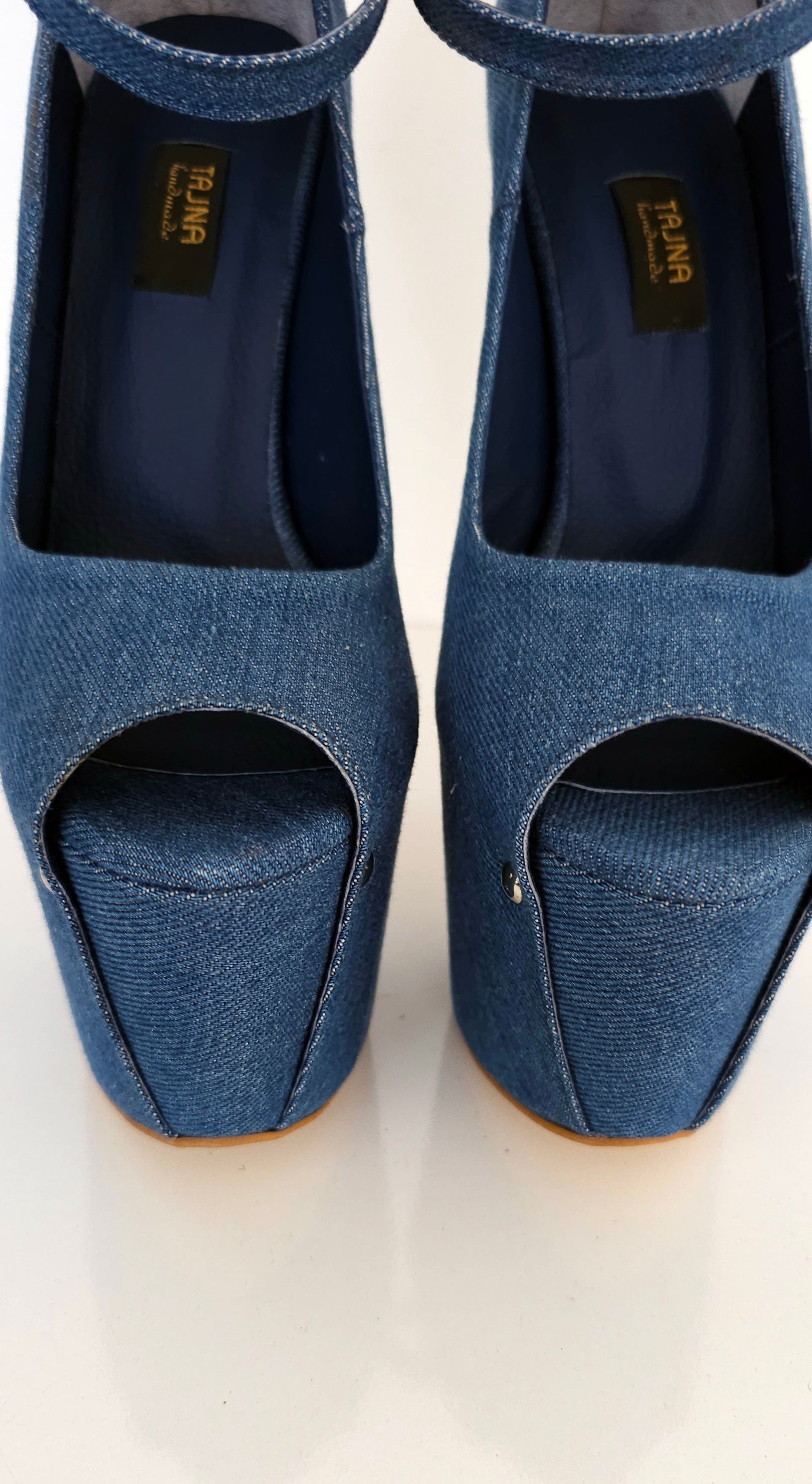 Pair of blue open-toe shoes on a white background