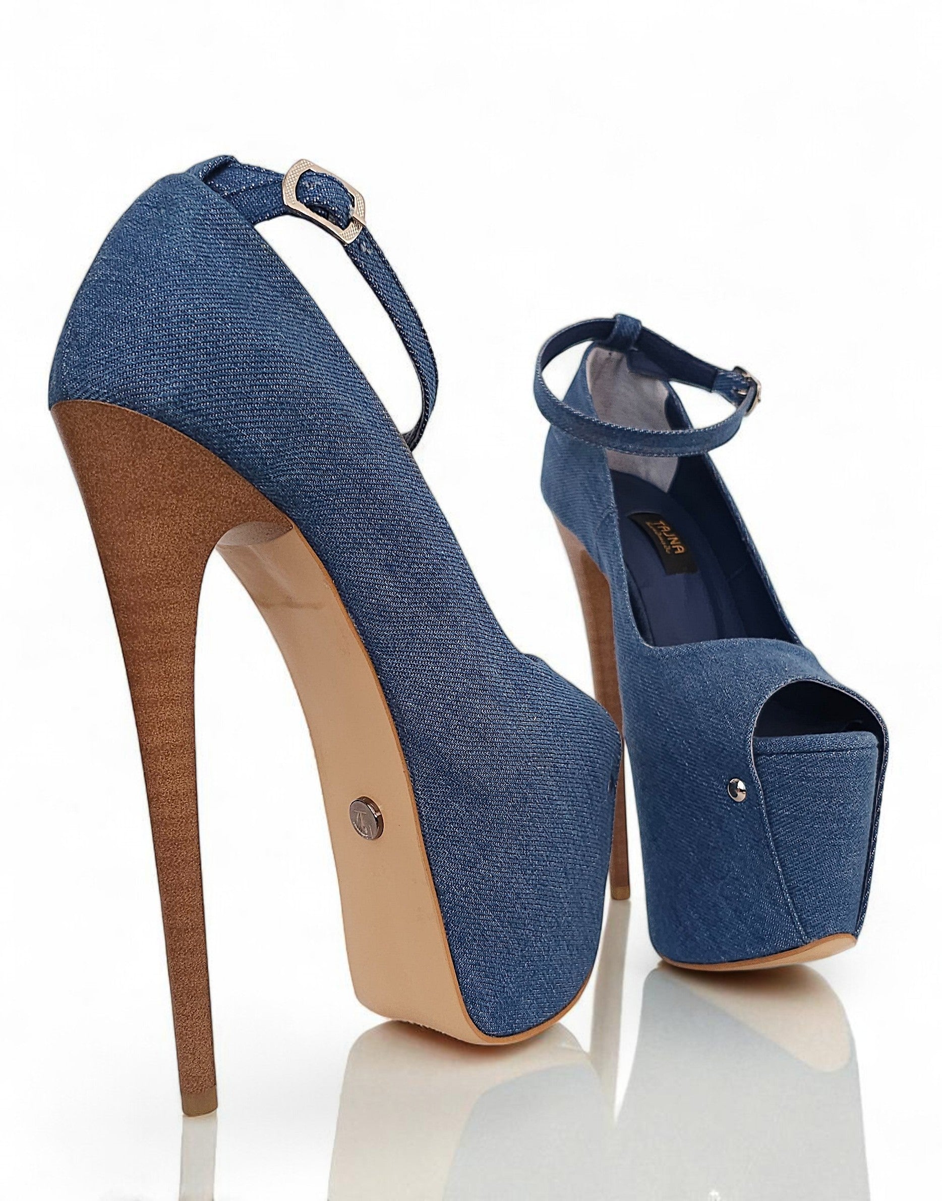 Blue denim high-heeled shoes with brown soles on a white background