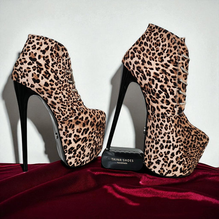 Leopard print high-heeled shoes on a red surface with a white background