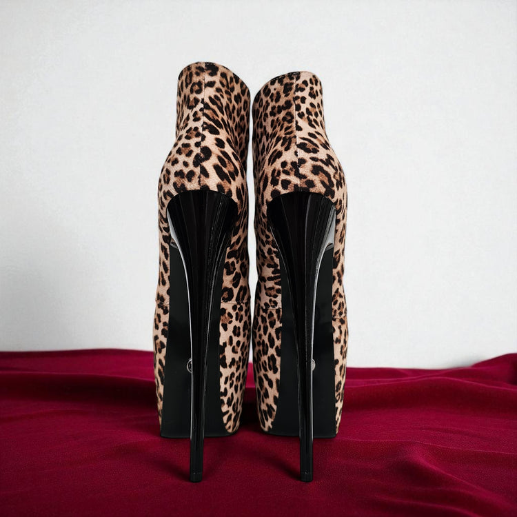 Leopard print high-heeled shoes on a red surface with a white background