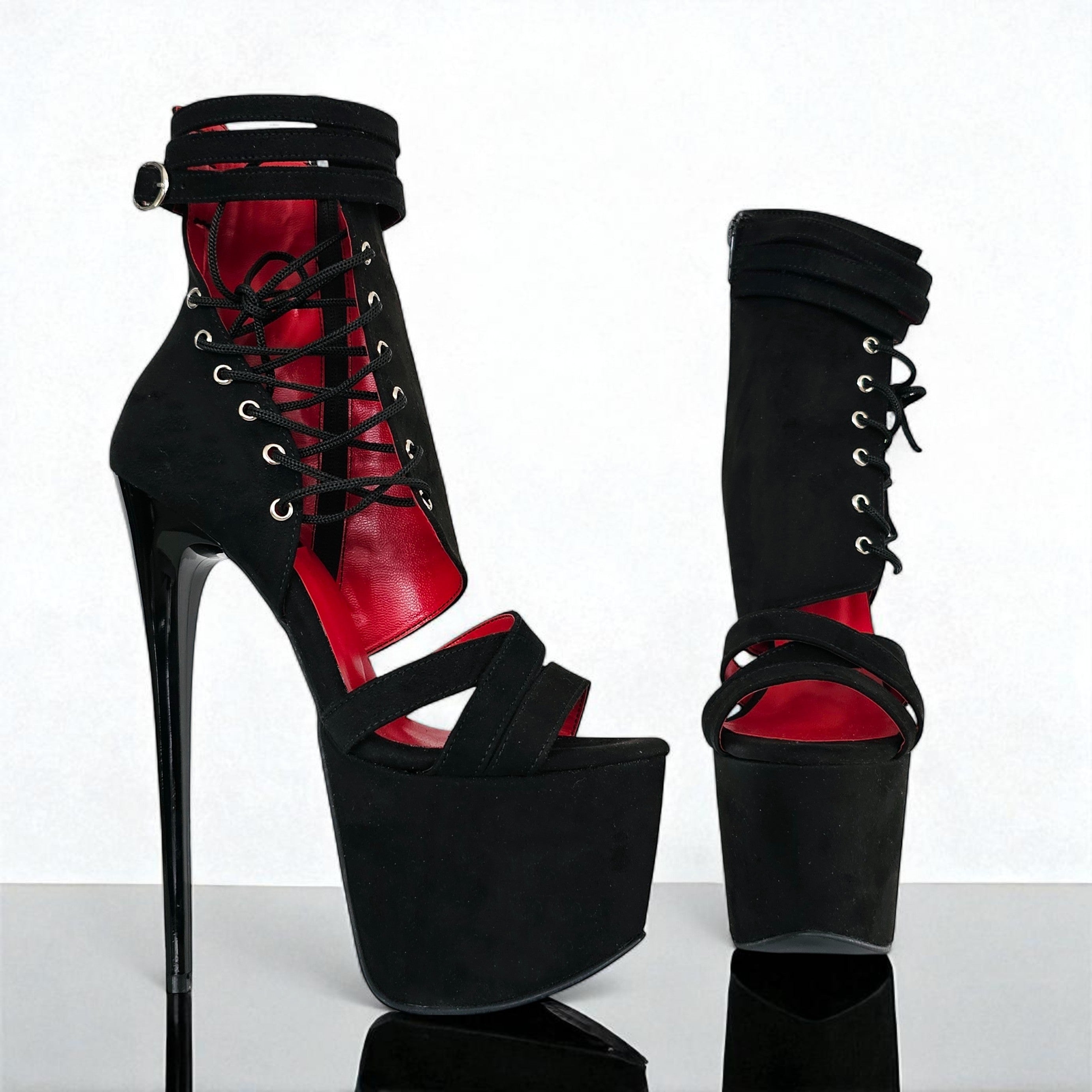 Black and red high-heeled platform shoes on a white background