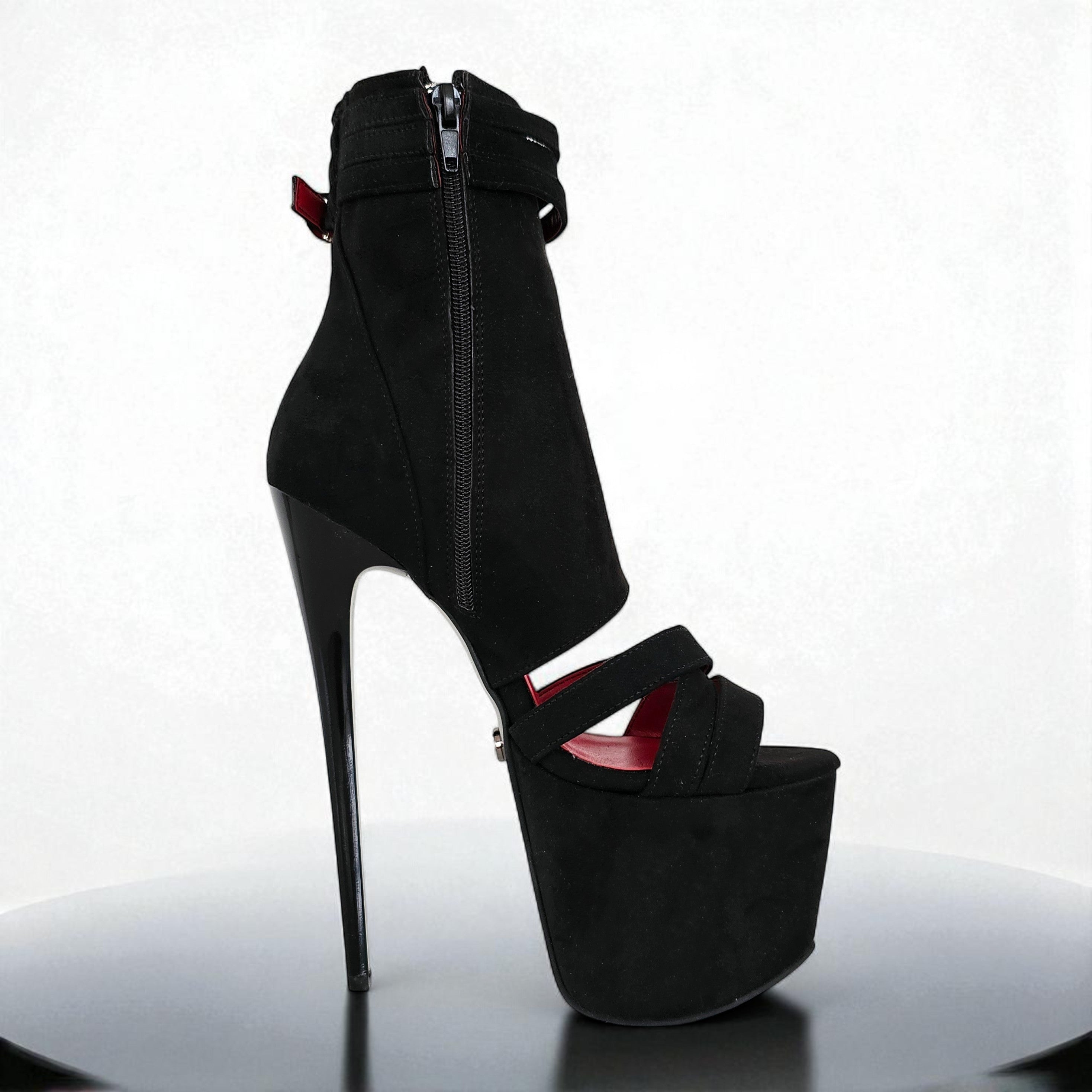 Black high-heeled platform shoe with a zipper on a white background