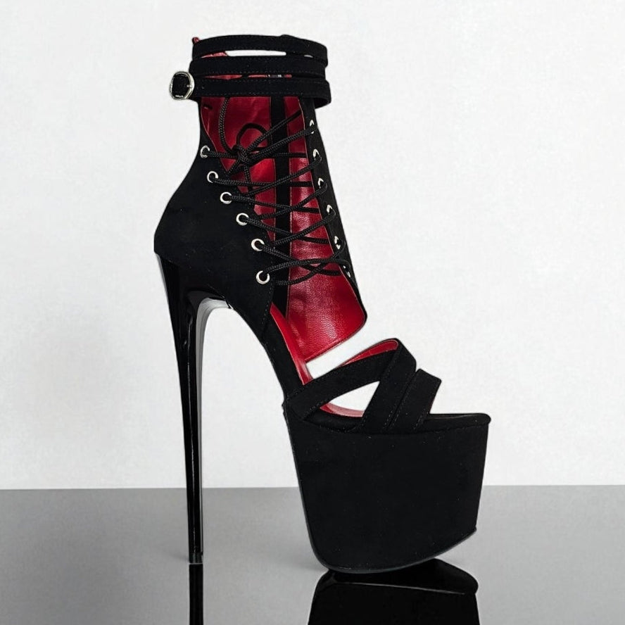Black and red high-heeled platform shoe on a white background